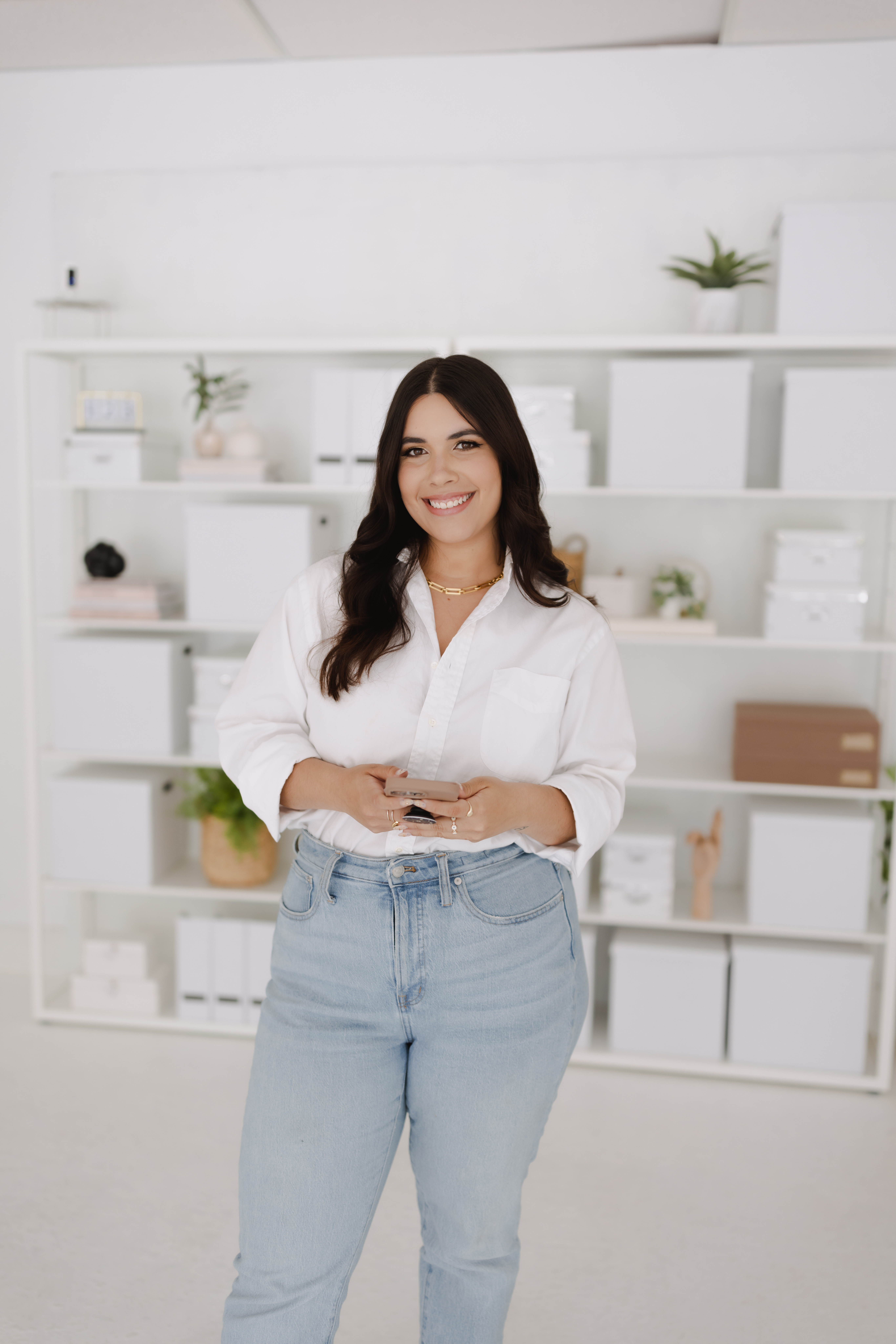 Alex standing in a white shirt and jeans